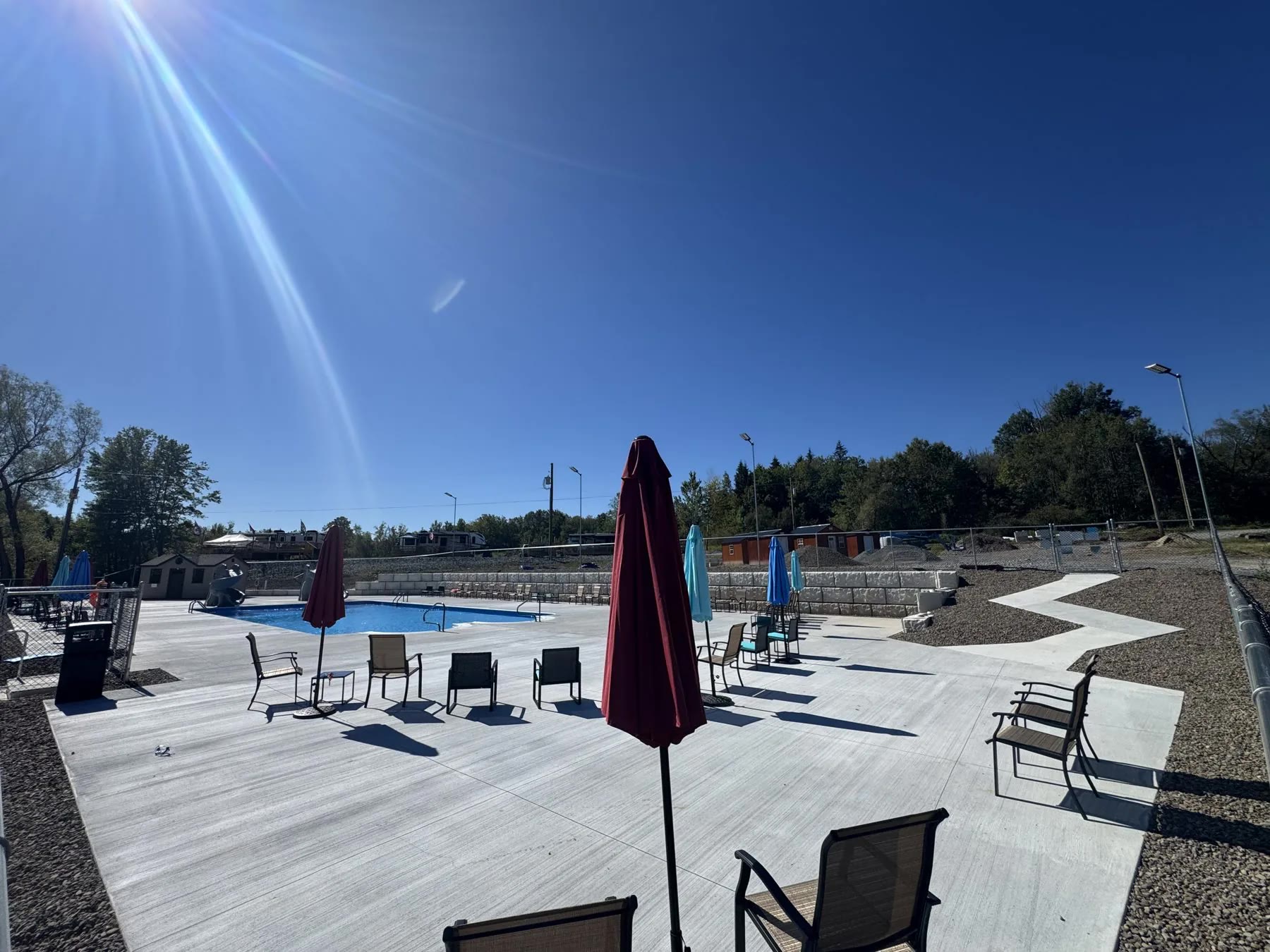 Finished commercial pool area concrete and hardscaping by ASRE