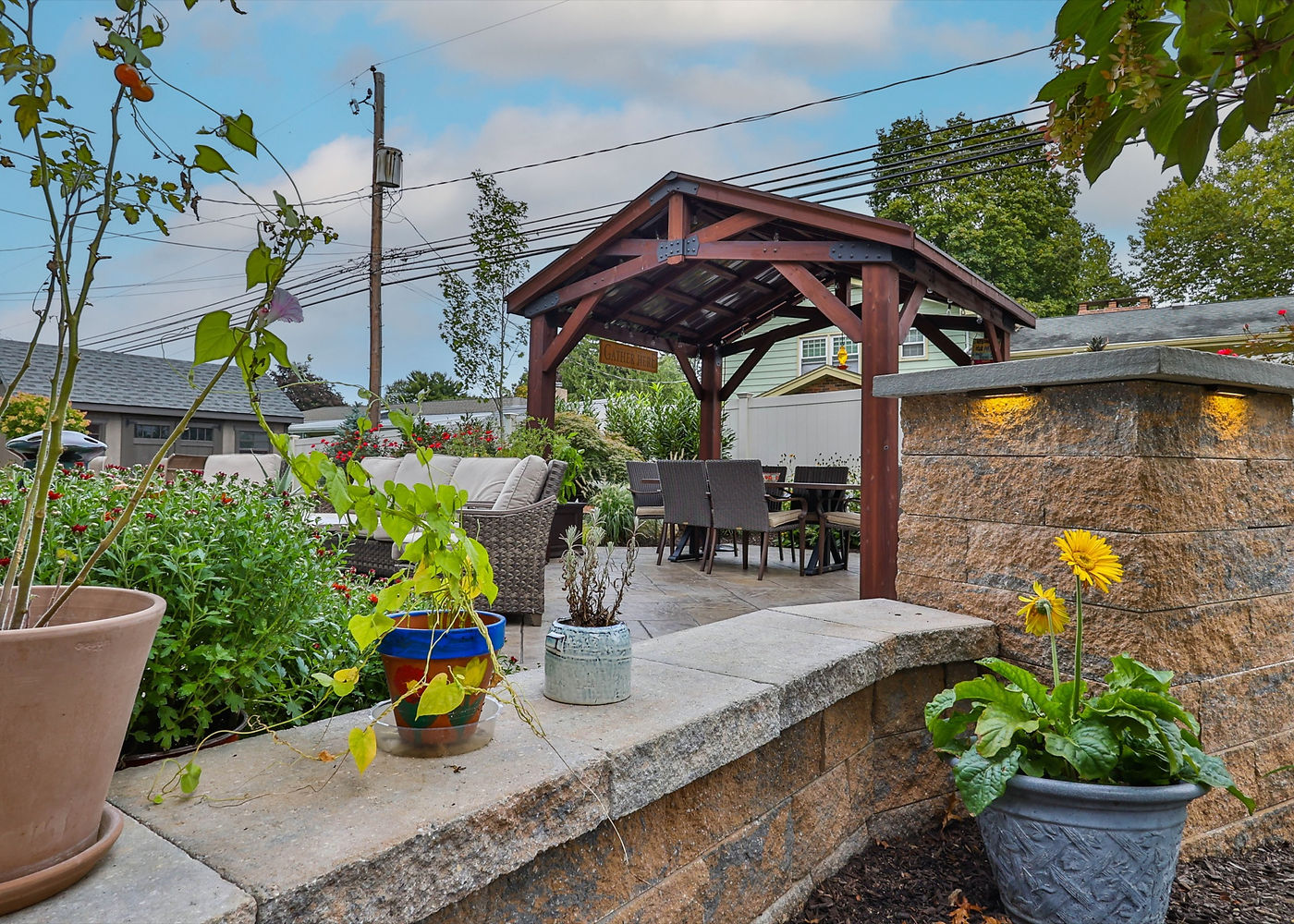 Meadowbrook Circle pergola patio with landscaping and stonework by ASRE