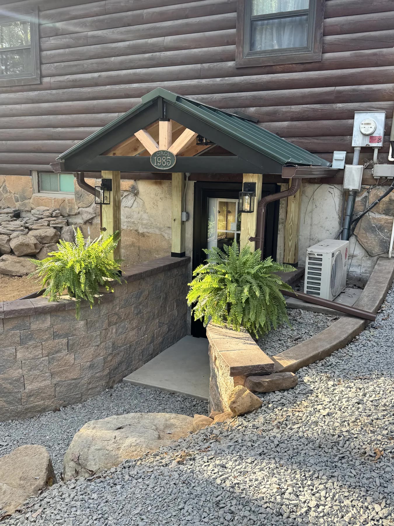 Finished lower-level entry with rebuilt retaining wall and stonework by ASRE