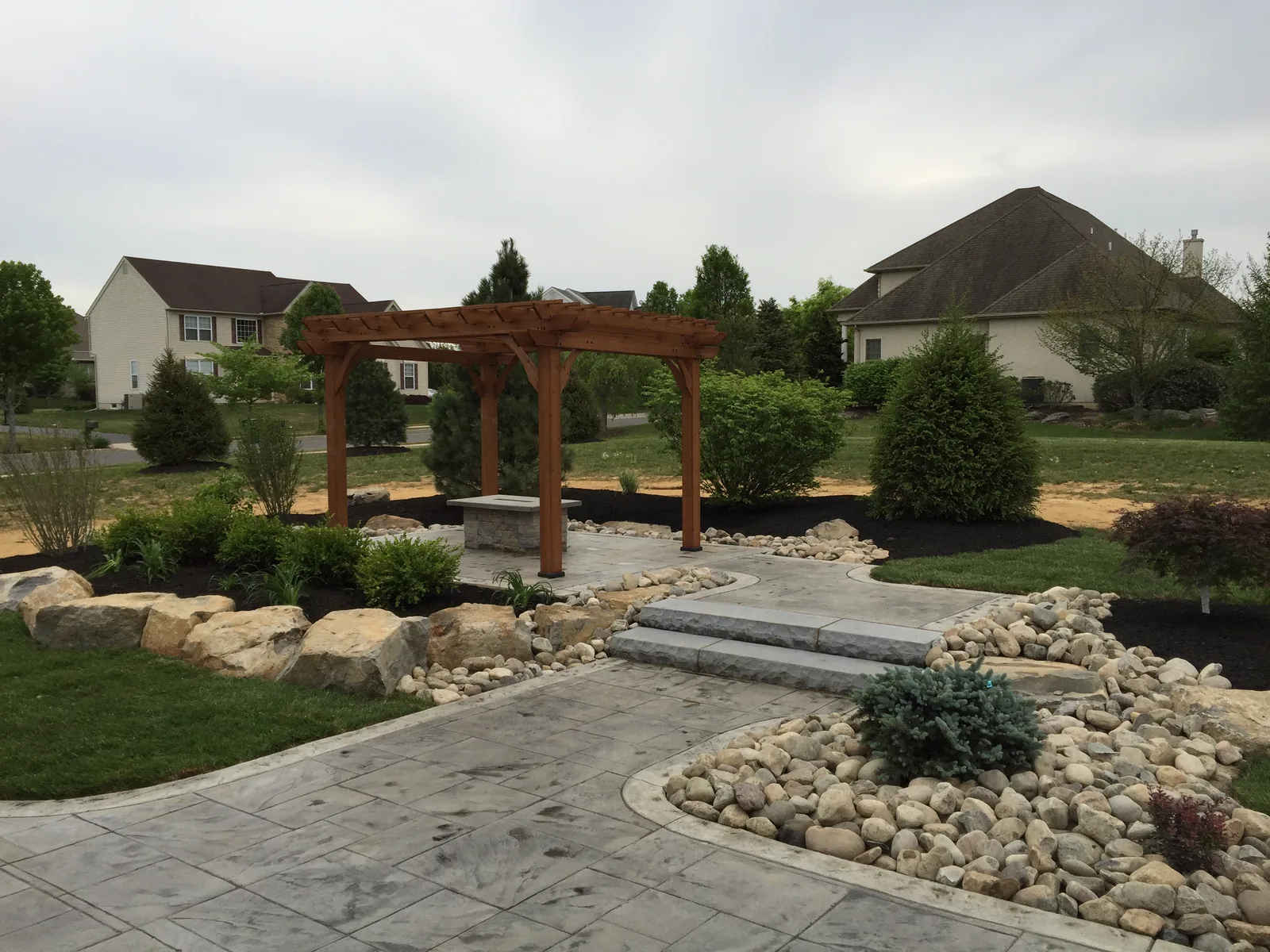 Custom hardscape with fire feature and pergola