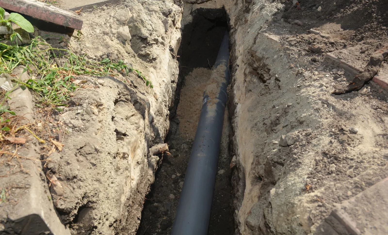 A sewer line being dug up for repairs